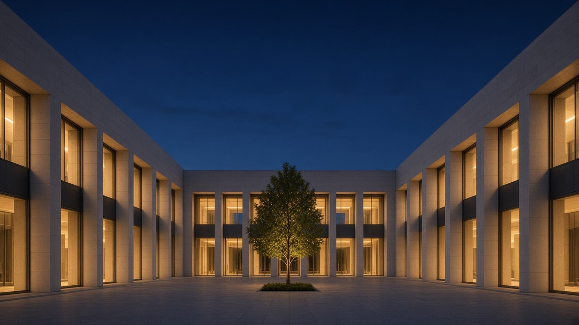 Stone courtyard of a formal civic building at blue hour